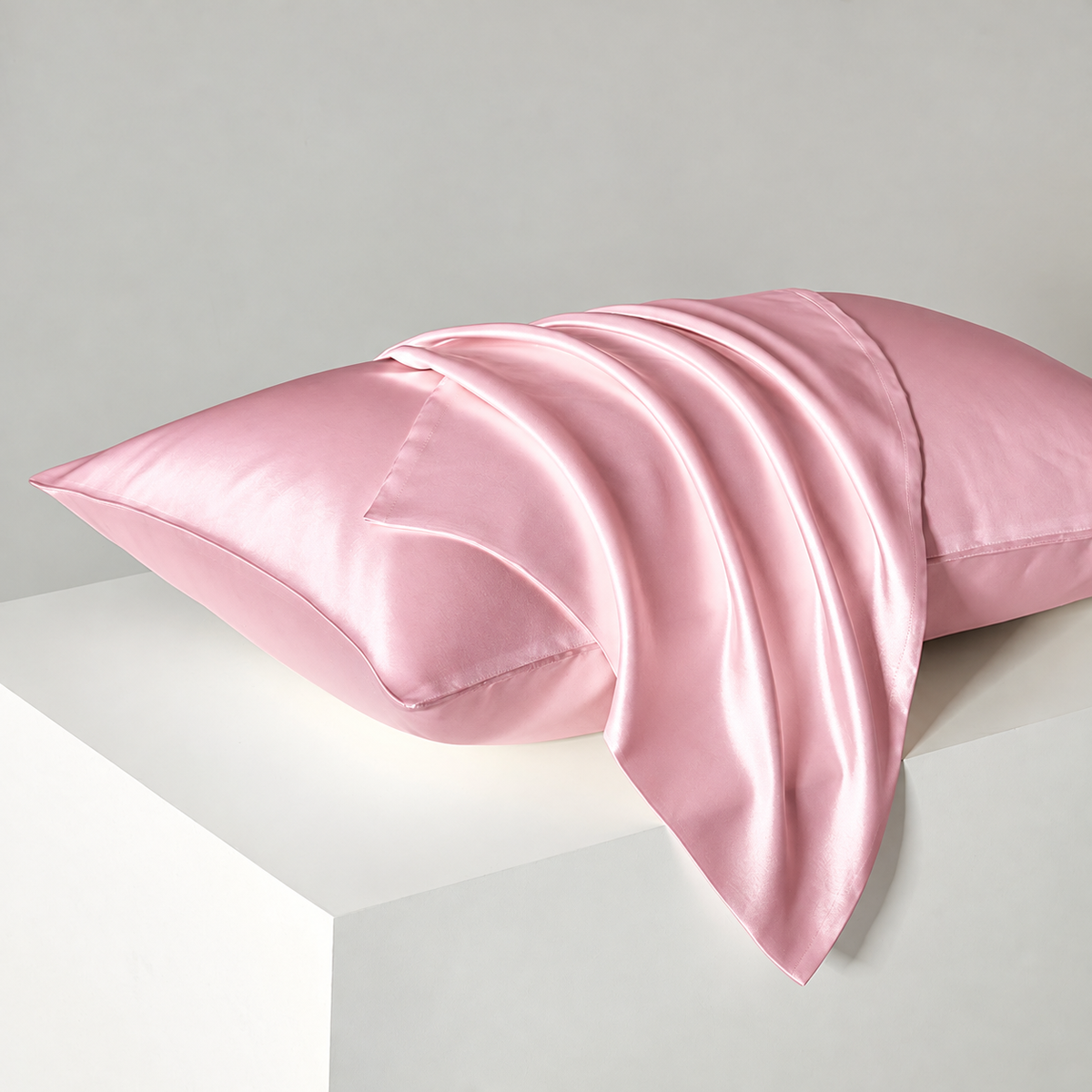Rose Pink satin pillowcases — diagonal studio view