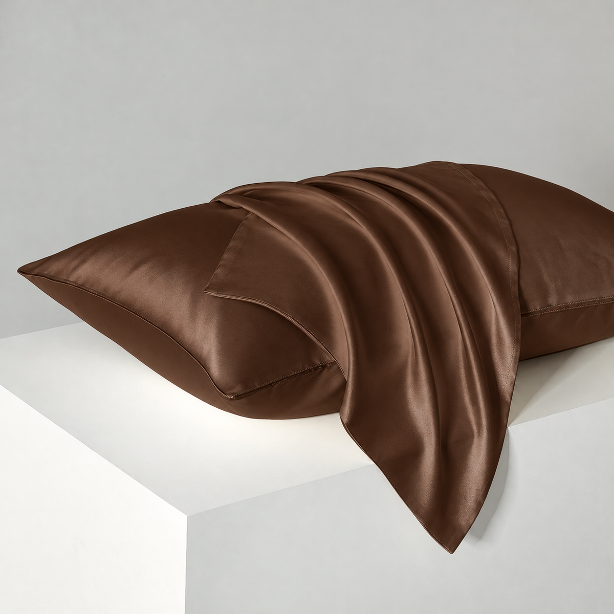 Coffee satin pillowcases — diagonal studio view